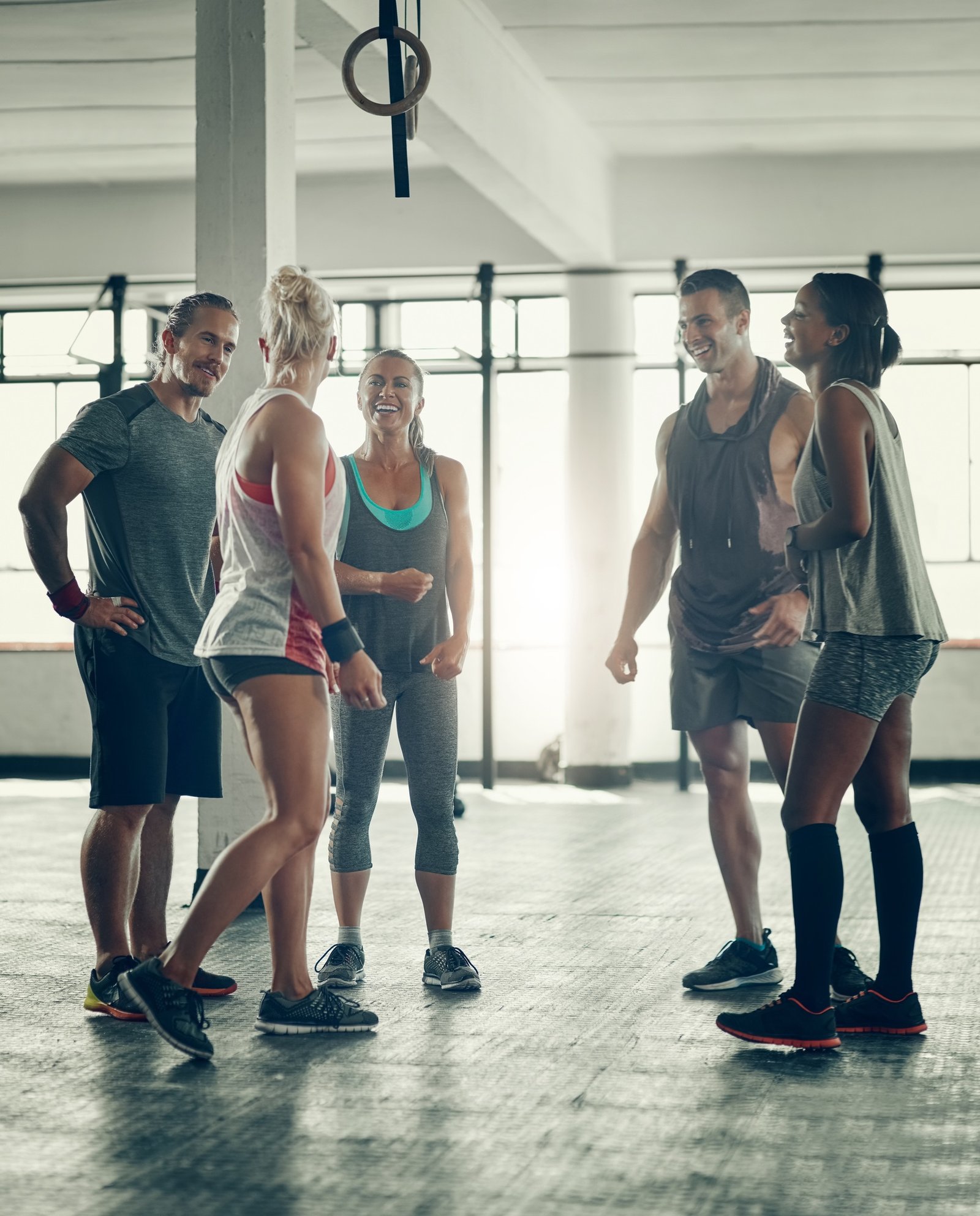 Shot of a group of young people working out together at the gym